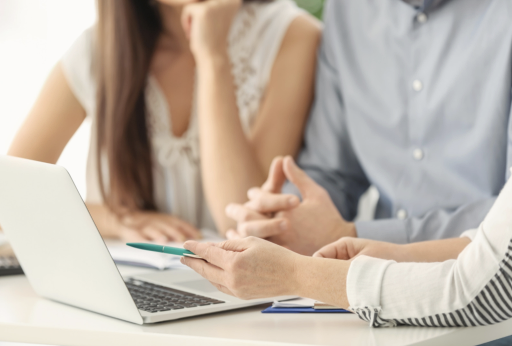 People using a computer to understand factors influencing pension payouts